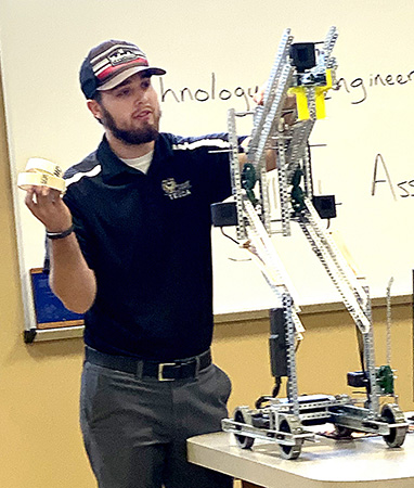 FHSU sophomore Tage Rothchild, a member of last year’s national runner-up robotics team, talks to high school students visiting campus earlier this semester during the Department of Applied Technology’s Junior-Senior Day. 