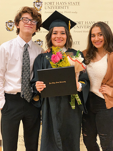 Jenice Hernandez, center, celebrates her graduation from Fort Hays State with her brother, Erick Alexander Chavarria, and her twin sister, Jasmine Hernandez.