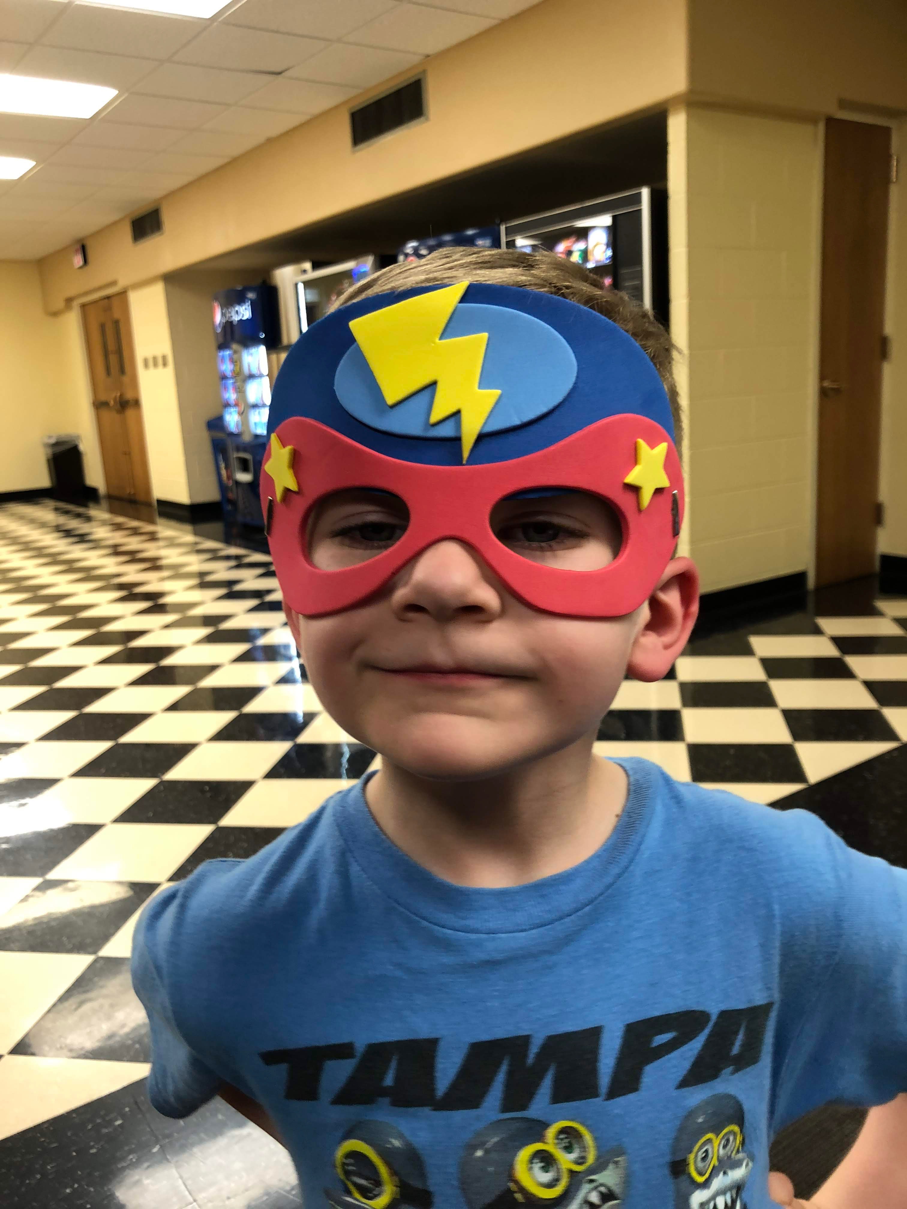 Ryker Mooney, younger brother of Fort Hays State University student Rylee Mooney, shows off a mask he made during a craft session at last year's Little Siblings Weekend.